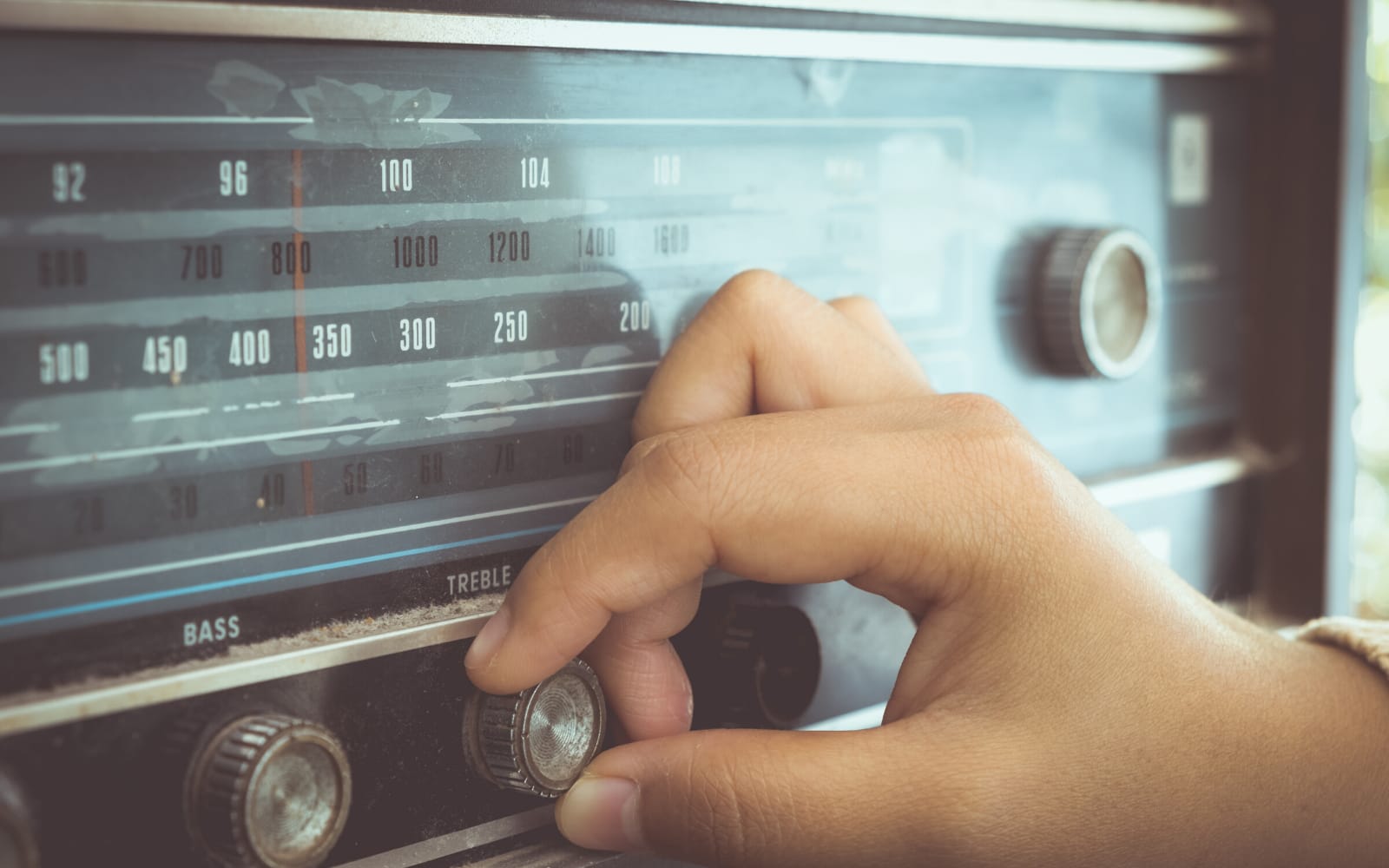 Hand on radio to illustrated that you need to listen to get rid of your foreign accent